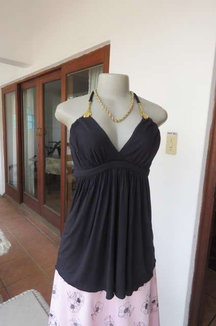 Ultra sexy black halterneck top in size 36/12. Gilded attachment on straps by 'Eringi'.