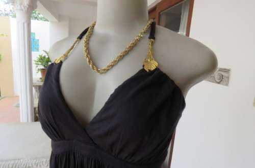 Ultra sexy black halterneck top in size 36/12. Gilded attachment on straps by 'Eringi'.