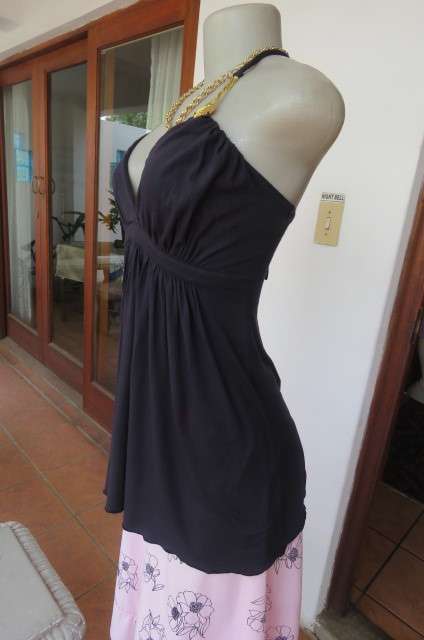 Ultra sexy black halterneck top in size 36/12. Gilded attachment on straps by 'Eringi'.