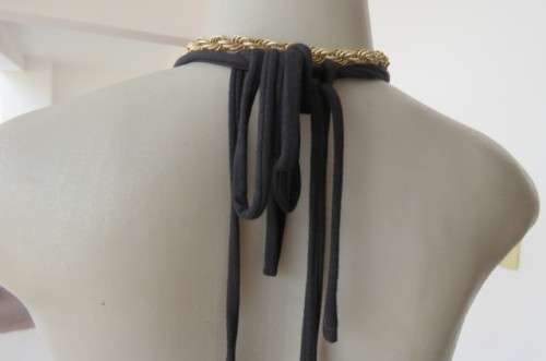 Ultra sexy black halterneck top in size 36/12. Gilded attachment on straps by 'Eringi'.