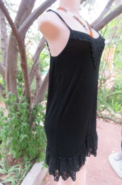 Ultra sexy black strappy dress in stretch viscose size 34/10. Loose hanging. Lace frills.As new