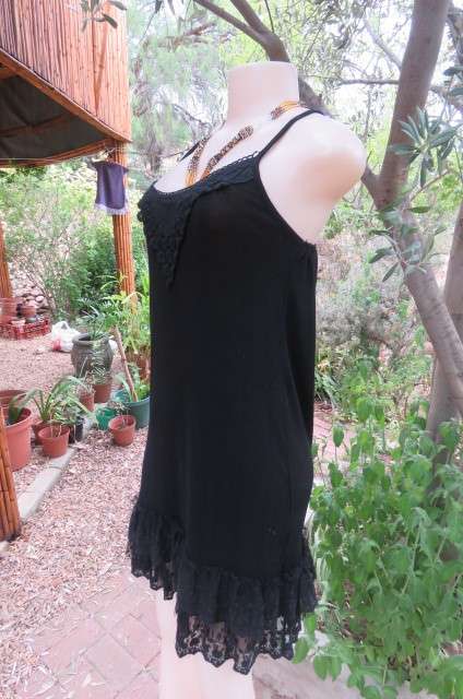 Ultra sexy black strappy dress in stretch viscose size 34/10. Loose hanging. Lace frills.As new