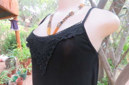 Ultra sexy black strappy dress in stretch viscose size 34/10. Loose hanging. Lace frills.As new