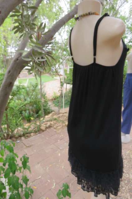 Ultra sexy black strappy dress in stretch viscose size 34/10. Loose hanging. Lace frills.As new