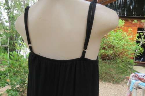 Ultra sexy black strappy dress in stretch viscose size 34/10. Loose hanging. Lace frills.As new