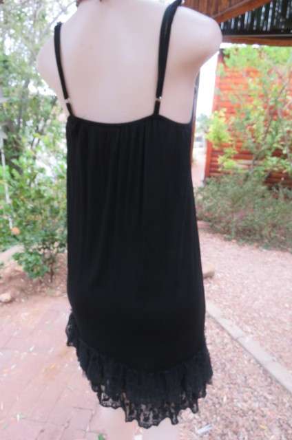 Ultra sexy black strappy dress in stretch viscose size 34/10. Loose hanging. Lace frills.As new