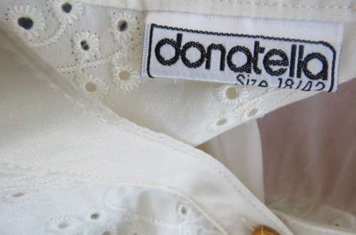 Top of the line rich cream short sleeve top by 'Donatella' size 42/18. As new