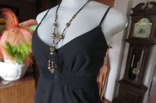 Cute black strappy top with wide elasticated waist by `RT` in size 32/8. Tiestring around hips.