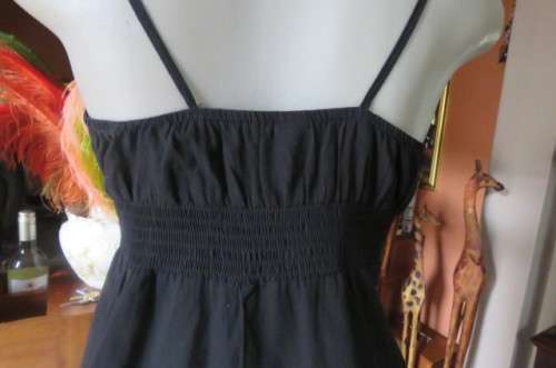 Cute black strappy top with wide elasticated waist by `RT` in size 32/8. Tiestring around hips.