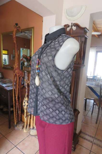 Cheeky patterned monochrome sleeveless top with black collar by `Audacity` in size 38/14. As new.
