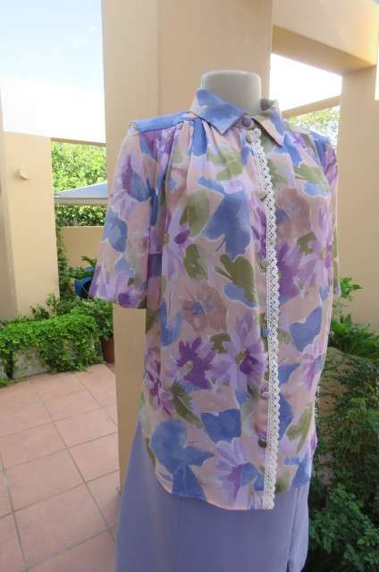 Smart dull pink with purple, blue and green floral pattern top size 34/10. Short sleeves.