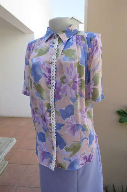 Smart dull pink with purple, blue and green floral pattern top size 34/10. Short sleeves.