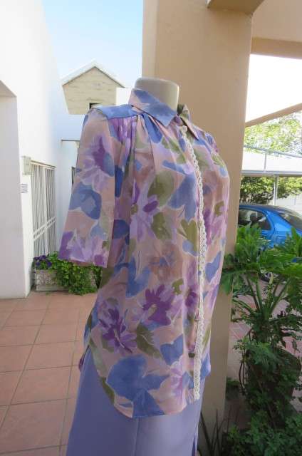 Smart dull pink with purple, blue and green floral pattern top size 34/10. Short sleeves.