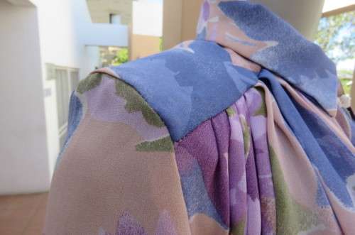 Smart dull pink with purple, blue and green floral pattern top size 34/10. Short sleeves.