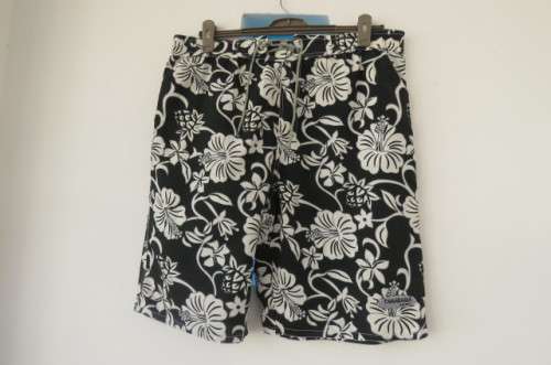 Men's black,white and grey floral TAMARAMA surf shorts in size Large. In 100% polyester fabric.