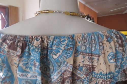 Attention grabbing turqouise and cream top by WWW in size 38/14. In creased polyester. As new.