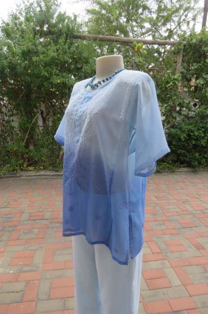 Embellished short sleeve top in different blue colours. Size 40/16. In sheer polyester. As new
