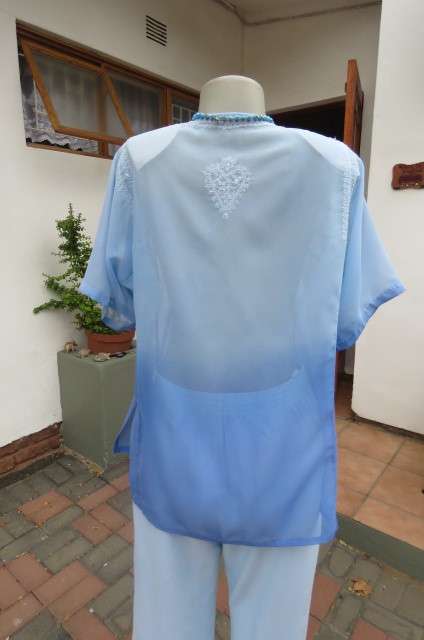 Embellished short sleeve top in different blue colours. Size 40/16. In sheer polyester. As new