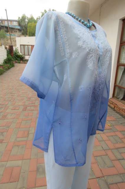 Embellished short sleeve top in different blue colours. Size 40/16. In sheer polyester. As new