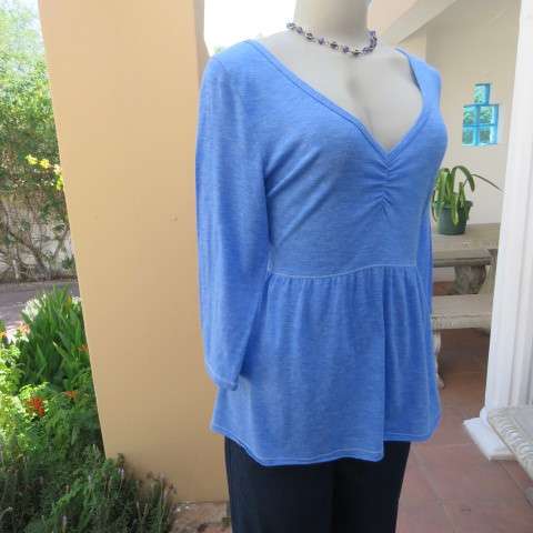 Skyblue peplum top by HOLLISTER Californiain size 38/14. Wide neckline with V front. Soft fabric.