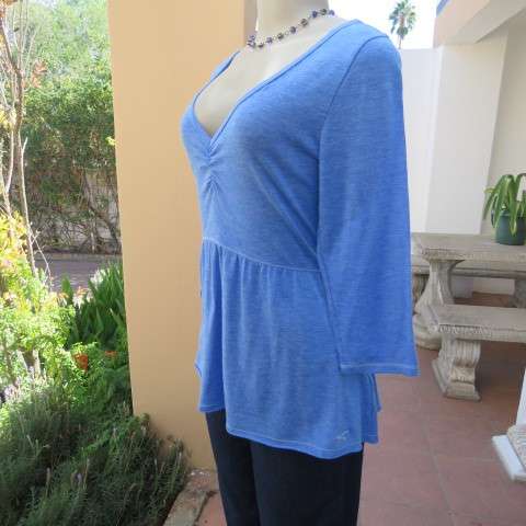 Skyblue peplum top by HOLLISTER Californiain size 38/14. Wide neckline with V front. Soft fabric.