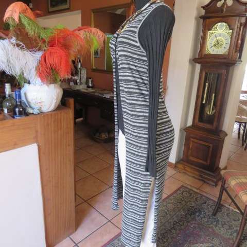 Black and white horizontal striped sleeveless coat with long slitted sides. Size 32/8 by AMARA