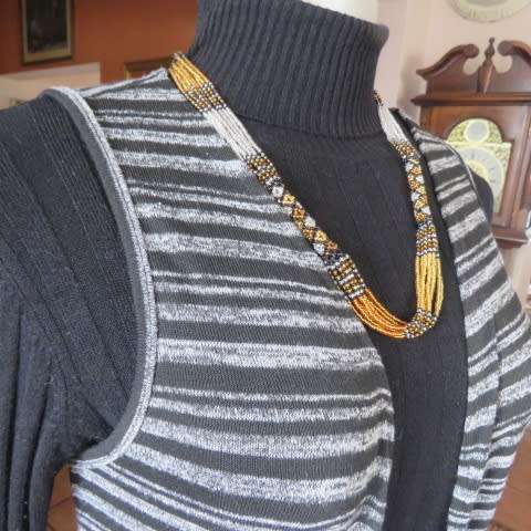 Black and white horizontal striped sleeveless coat with long slitted sides. Size 32/8 by AMARA