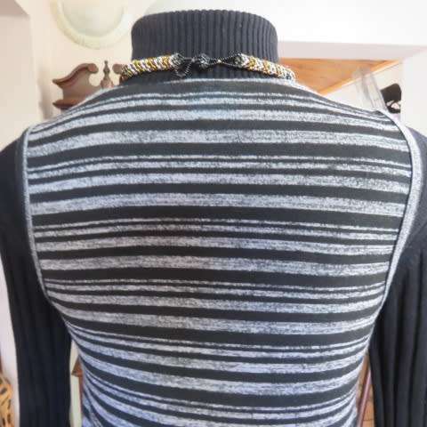 Black and white horizontal striped sleeveless coat with long slitted sides. Size 32/8 by AMARA