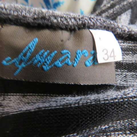 Black and white horizontal striped sleeveless coat with long slitted sides. Size 32/8 by AMARA