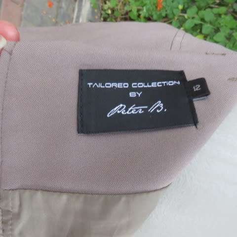 High quality calf length fully lined khaki colour skirt. Styled to perfection by Peter B` size 36/12