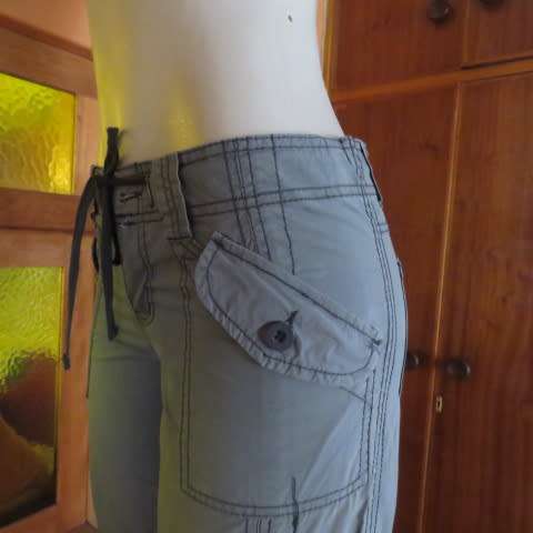 Grey casual pants by `Deniim + Co. In size 32/8. Cargo pockets on front. Tiestring in waist. As new.