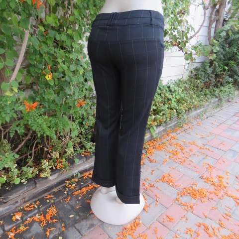 Beautiful black pants with large white check pattern.Yoked back.Size 31/7. Bootlegged. New cond.