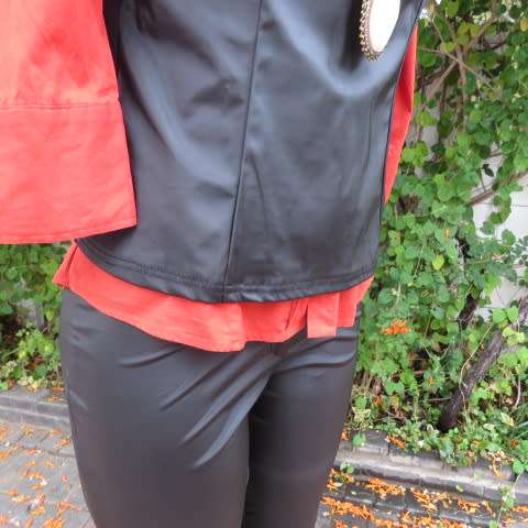 Black shiny pull over V neck ,sleeveless top that resembles vinyl on front. Size 34/10 by BESTS.