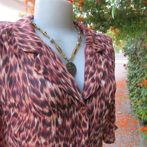 Pretty animal print top in brown colours by Kelso in size 34/10. Button down front with open collar.