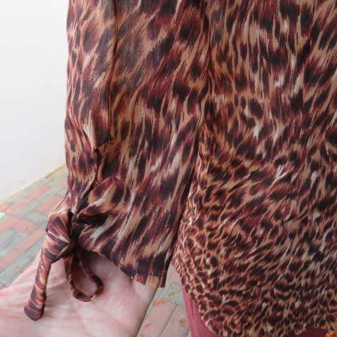 Pretty animal print top in brown colours by Kelso in size 34/10. Button down front with open collar.
