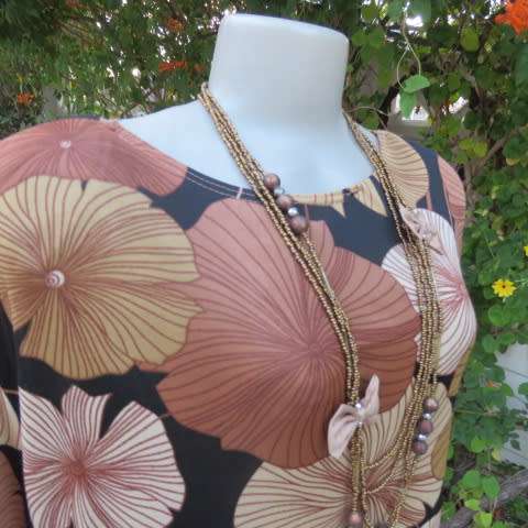 Silky dark brown slip over top with bold beige,gold and brown floral pattern. Short sleeves. Size 50