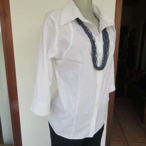 Snow white button down top with cuffed bracelet length sleeves.By MICHAELA in size 38/14