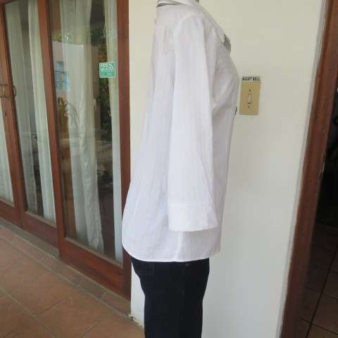 Snow white button down top with cuffed bracelet length sleeves.By MICHAELA in size 38/14