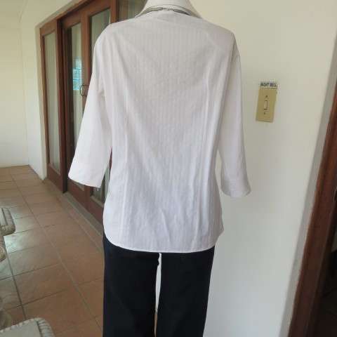 Snow white button down top with cuffed bracelet length sleeves.By MICHAELA in size 38/14