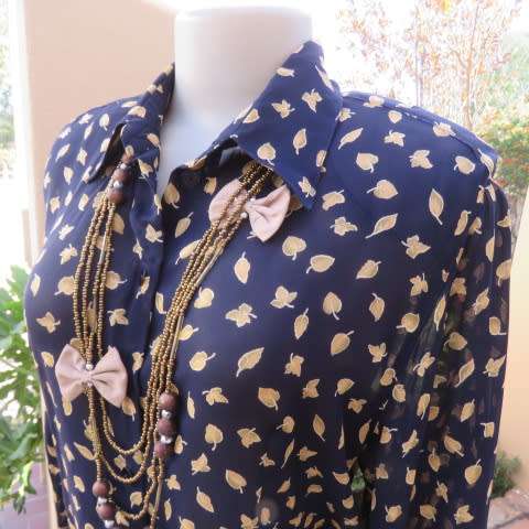 Absolute stunning long sleeve blouse from Germany in size 38/14 in navy with golden leaves. New cond