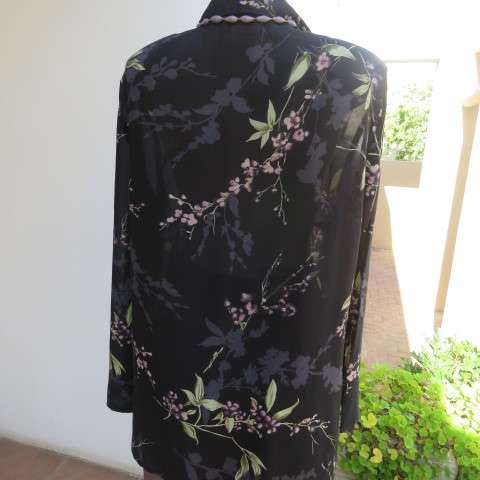 Pretty black sheer polyester long sleeve top with lilac,grey and green flowers. Size 42/18.Good cond