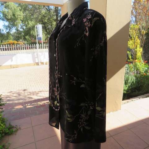 Pretty black sheer polyester long sleeve top with lilac,grey and green flowers. Size 42/18.Good cond