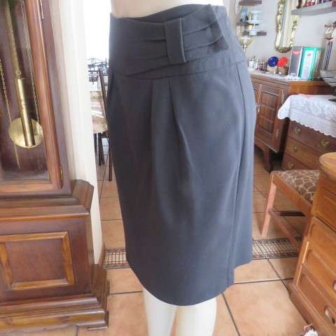 Must have smart black midi skirt with wide yoked waist with bow on left.Size 36/12 by STUDIO W.
