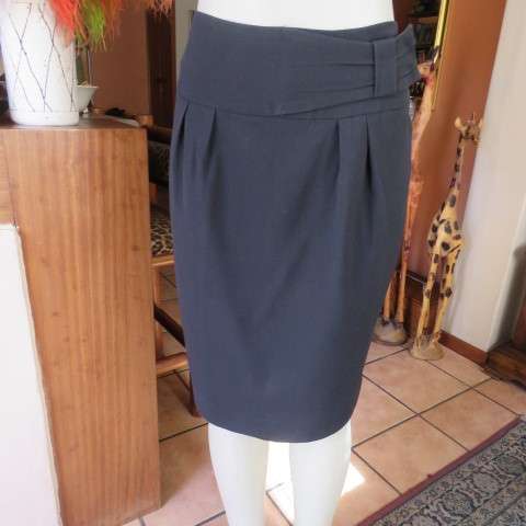 Must have smart black midi skirt with wide yoked waist with bow on left.Size 36/12 by STUDIO W.