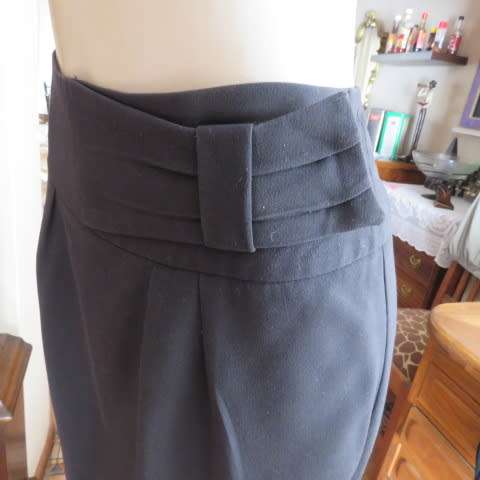 Must have smart black midi skirt with wide yoked waist with bow on left.Size 36/12 by STUDIO W.