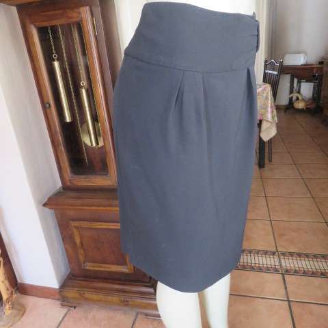 Must have smart black midi skirt with wide yoked waist with bow on left.Size 36/12 by STUDIO W.