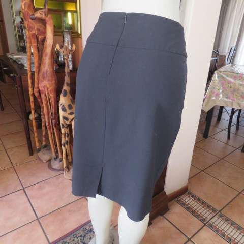 Must have smart black midi skirt with wide yoked waist with bow on left.Size 36/12 by STUDIO W.