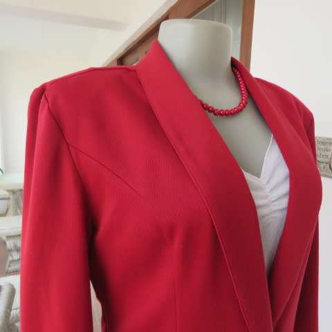 Show stopping red peacoat style long sleeve jacket closing with 2 buttons. Pleats at back.Size 34/10