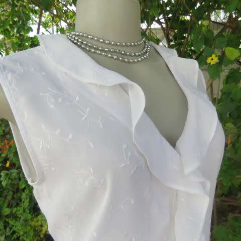 Dainty white sleeveless frilled top in sheer embroidered polyester. Size 36 By WOOLWORTHS.As new.