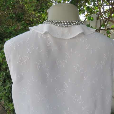 Dainty white sleeveless frilled top in sheer embroidered polyester. Size 36 By WOOLWORTHS.As new.